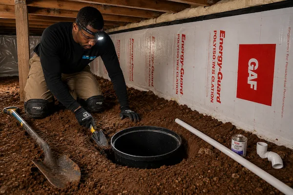 Technicians applying waterproofing membrane with sprayer